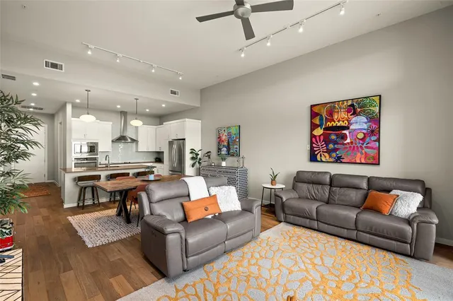 a view of a living room kitchen and a wooden floor