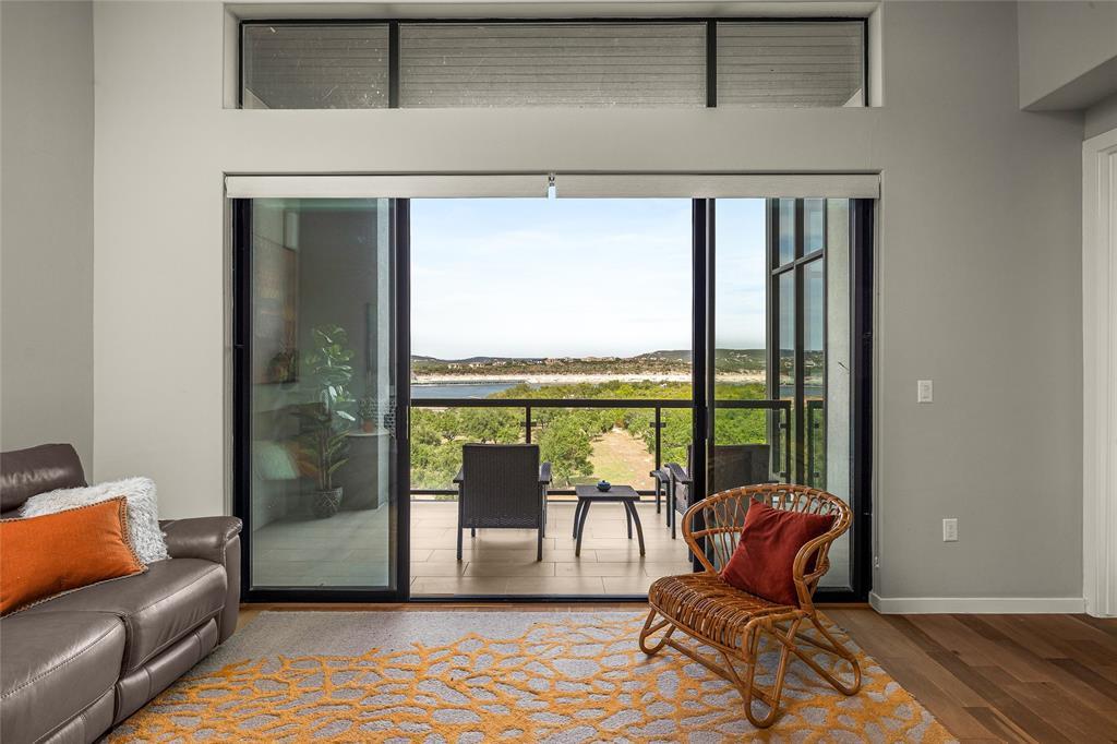 a living room with furniture and a floor to ceiling window