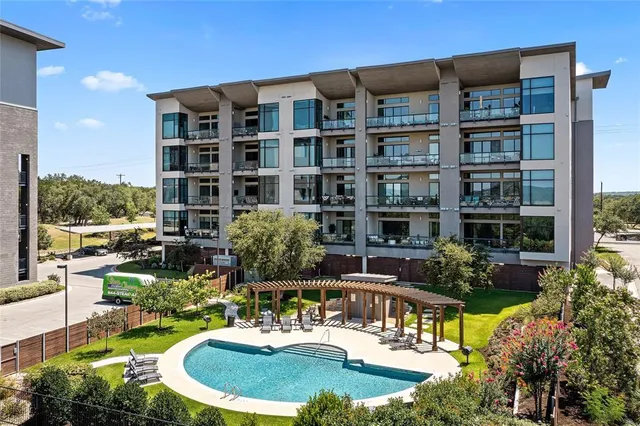 a swimming pool with outdoor seating and yard view