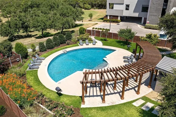 a view of a swimming pool with a yard
