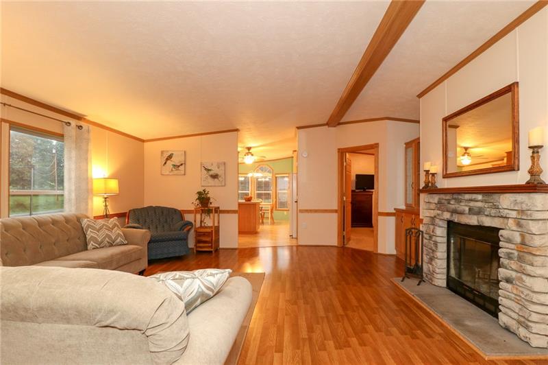 120 Goldscheitter Road Sarver, PA 16055 - Photo 4 of 20 THE LIVING ROOM FEATURES A LOG BURNING FIREPLACE WITH A BEAUTIFUL STONE SURROUND. PERFECT TO COZY UP THESE COLD WINTER NIGHTS.