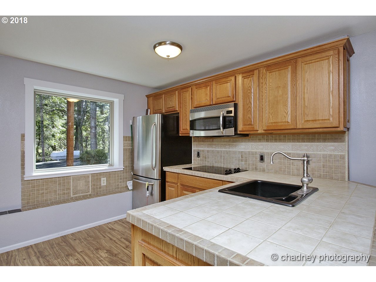 19971 Southeast Baty Road Sandy, OR 97055 - Photo 18 of 32 a kitchen with stainless steel appliances granite countertop a refrigerator sink and stove