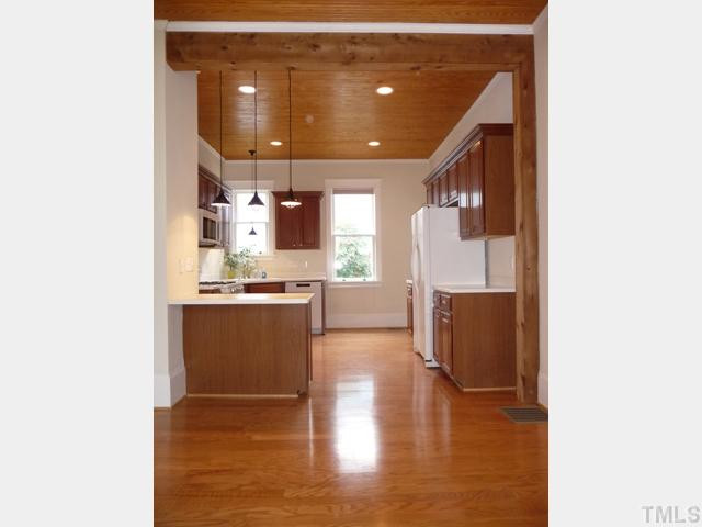 625 East Franklin Street Raleigh, NC 27604 - Photo 6 of 25 Adding to the loft-like feel is a symphony of wood tone colors and finishes that include the tall tongue-in-grove ceiling and rough-cut post and beam.