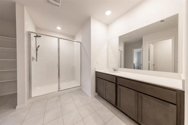 a bathroom with a double vanity sink and a mirror