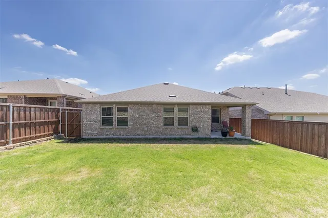 a view of a house with a yard and sitting area