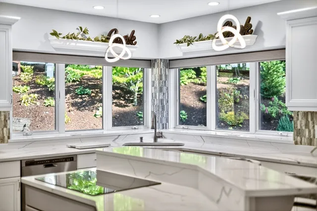 a view of a dining room with furniture a chandelier and wooden floor
