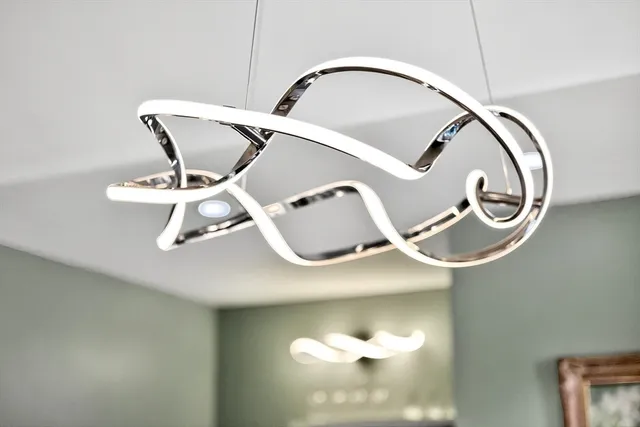 a living room with fireplace furniture and a large window