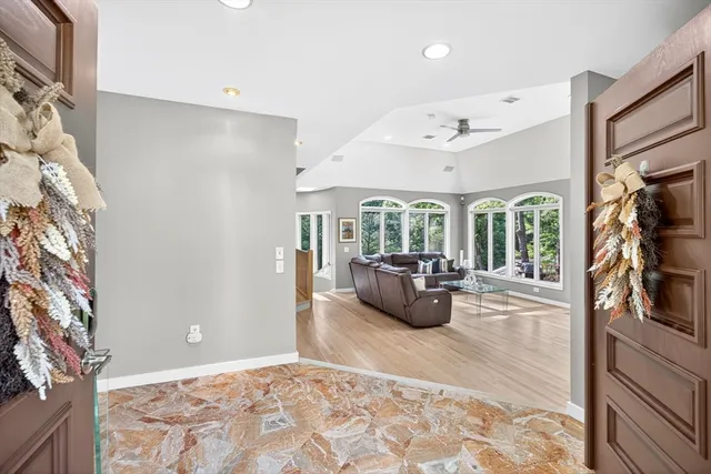a living room with furniture and large windows