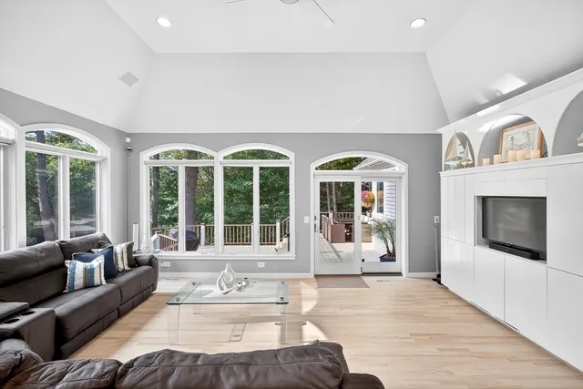 a living room with furniture and large windows