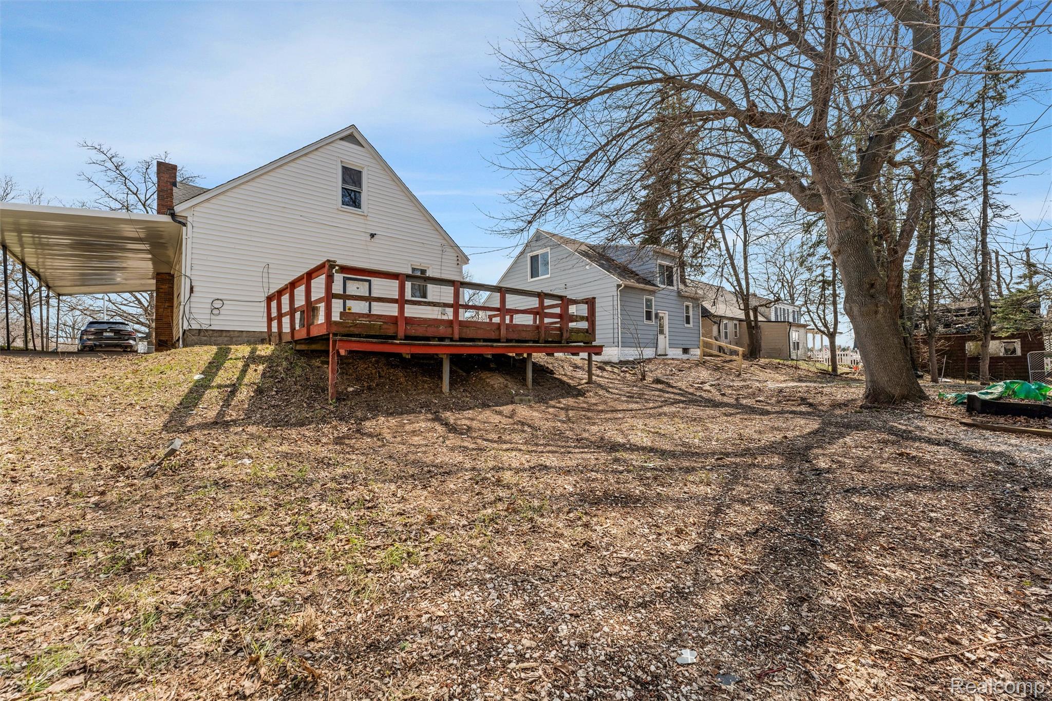 917 Perry Street Pontiac, MI 48340 - Photo 35 of 37 Back of house with a deck and a chimney