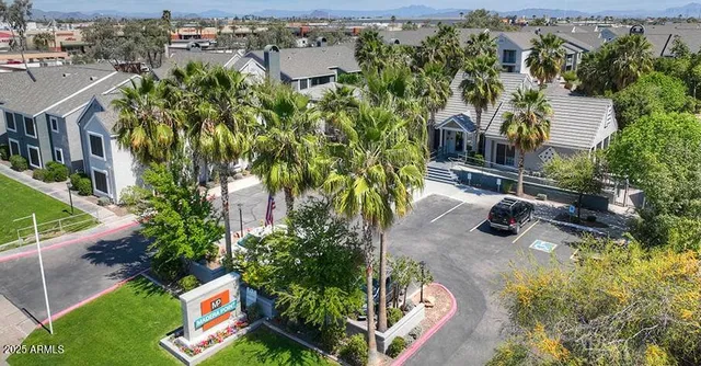 an aerial view of a house with swimming pool and garden