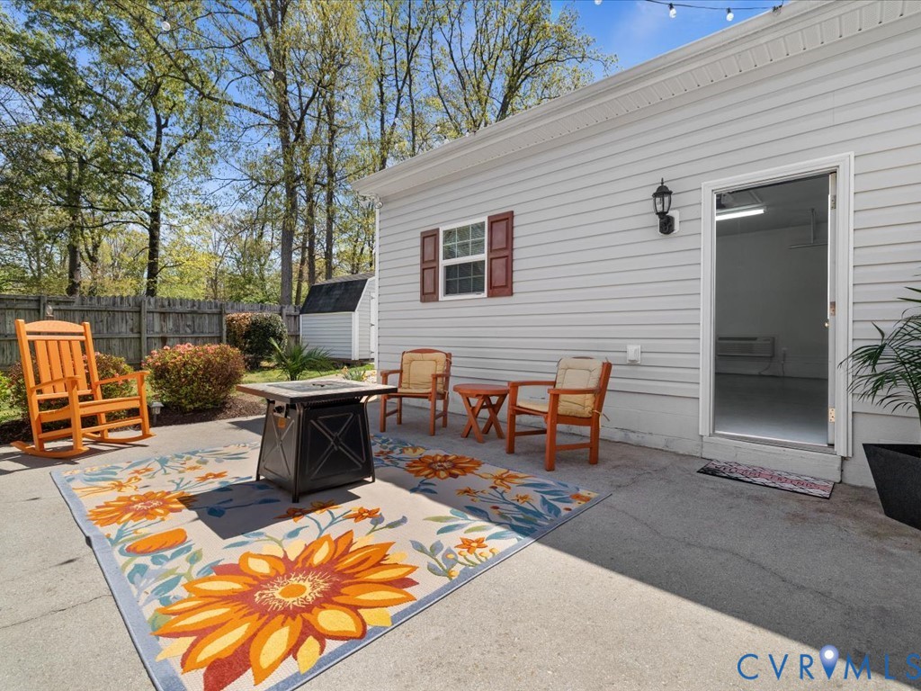 1455 Robindale Road Richmond, VA 23235 - Photo 25 of 29 a backyard of a house with barbeque oven table and chairs