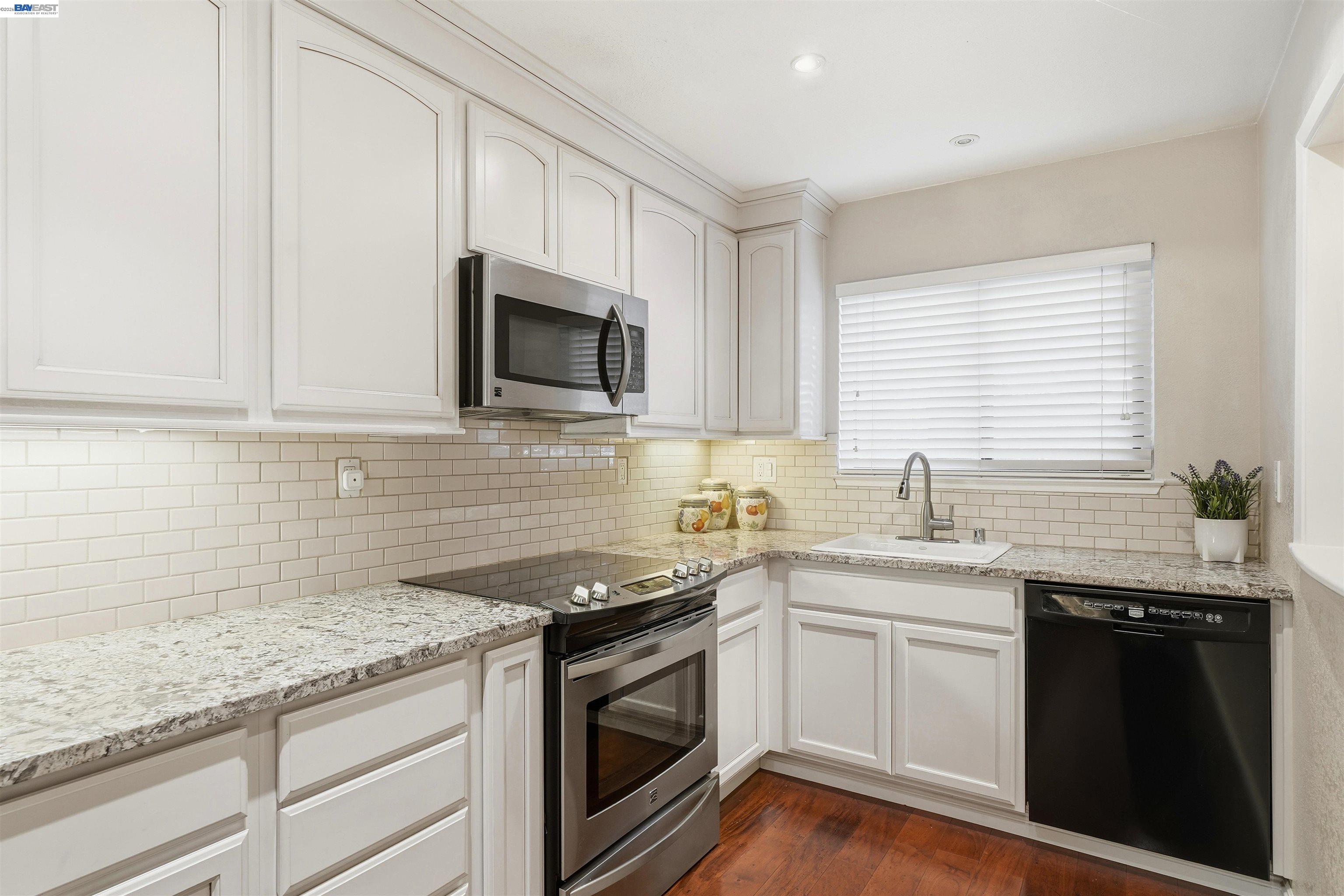 8985 Alcosta Boulevard, Unit 162 San Ramon, CA 94583 - Photo 14 of 33 a kitchen with granite countertop a sink stainless steel appliances and cabinets