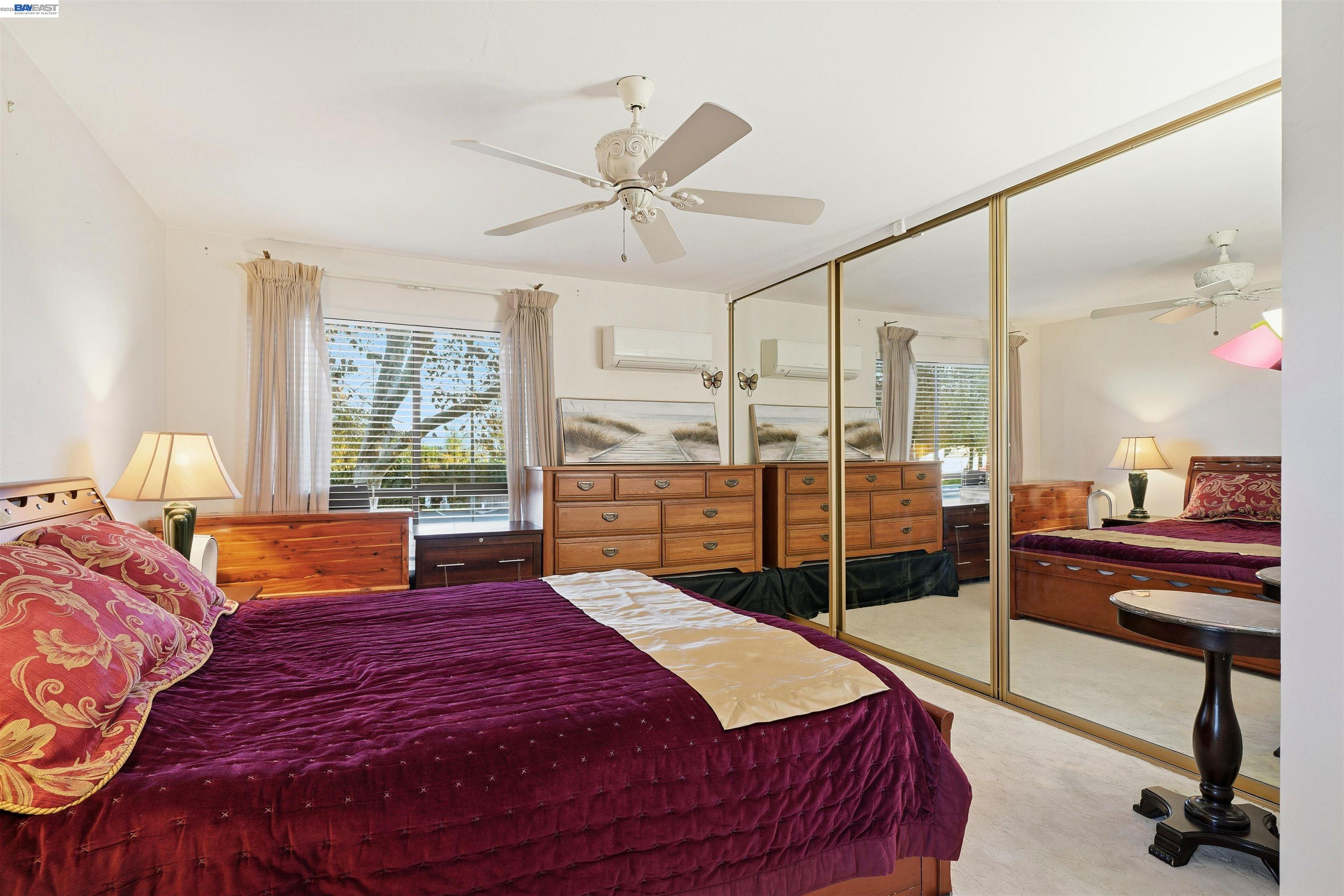 8985 Alcosta Boulevard, Unit 162 San Ramon, CA 94583 - Photo 24 of 33 a bedroom with a balcony a bed and a chandelier