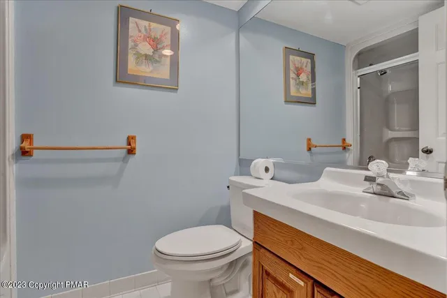 a view of a bathroom with a shower and a mirror