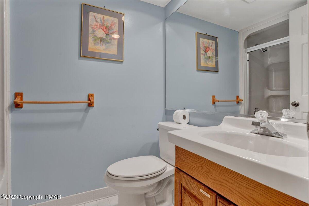 7 Midlake Drive, Unit 201A Lake Harmony, PA 18624 - Photo 13 of 34 a bathroom with a sink a toilet and a mirror