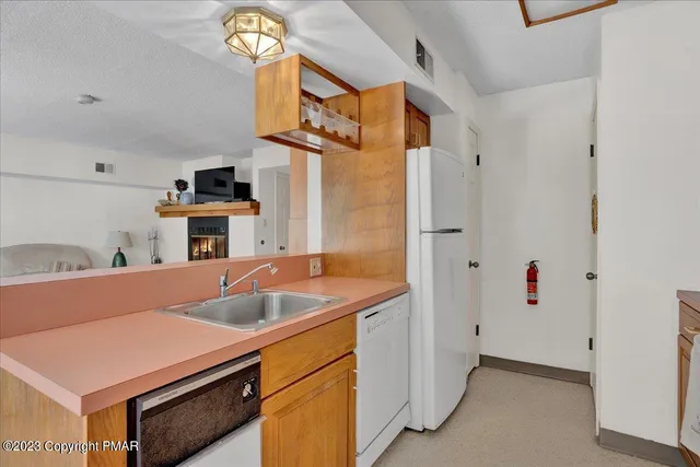 a kitchen with stainless steel appliances a stove microwave and a sink