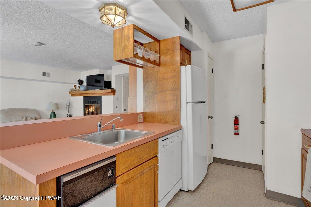 7 Midlake Drive, Unit 201A Lake Harmony, PA 18624 - Photo 26 of 34 a kitchen with stainless steel appliances granite countertop a sink and a refrigerator