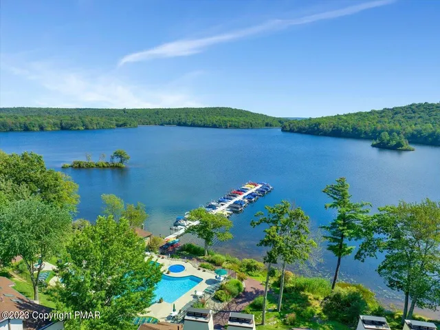 an aerial view of a houses with a lake view