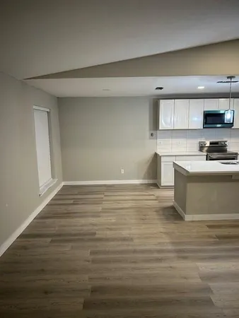 a kitchen with a stove sink and cabinets