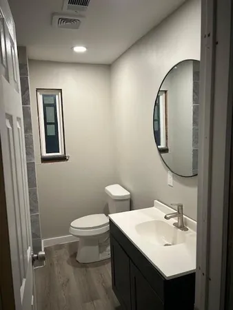 a kitchen with a sink a counter space and a ceiling fan