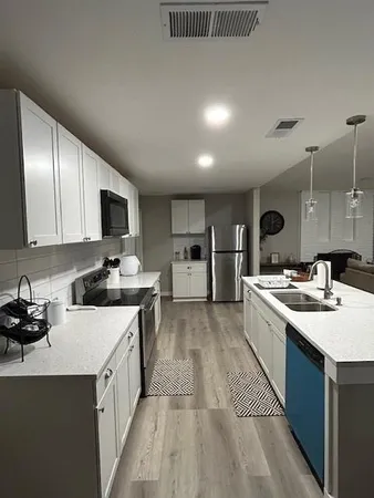 a kitchen with a sink stove and cabinets