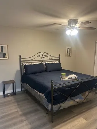 a bedroom with a bed and a ceiling fan