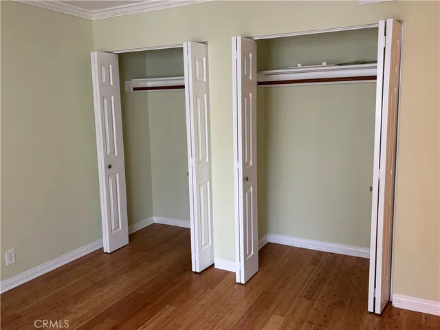 an empty room with wooden floor and a door
