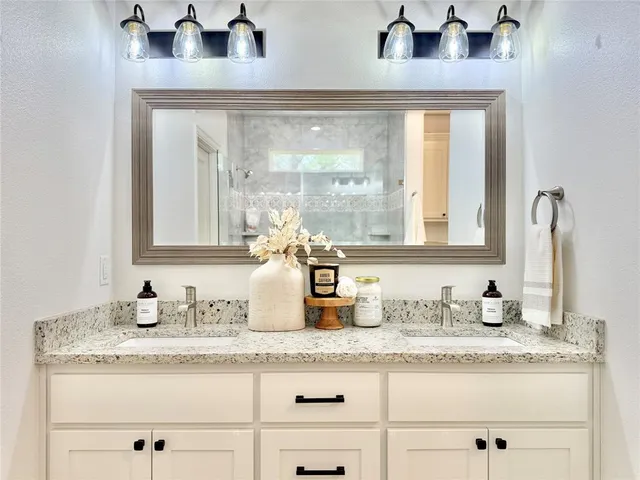 a bathroom with mirror vanity and window
