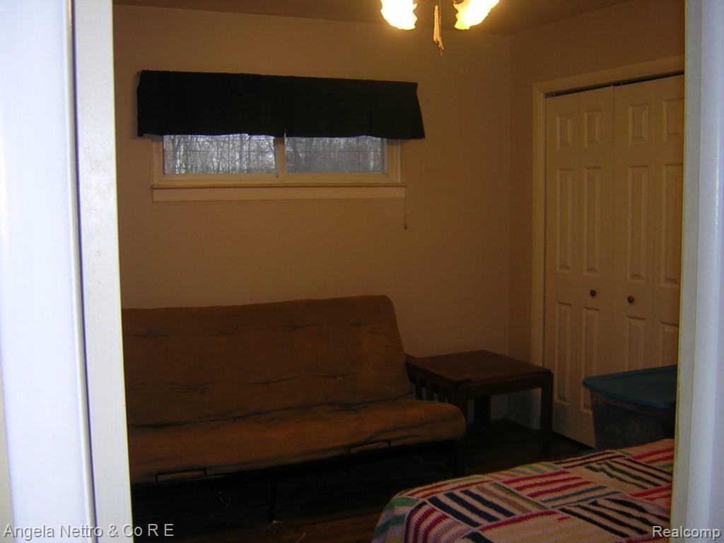 19700 Karr Road Belleville, MI 48111 - Photo 12 of 23 BEDROOM WITH CLOSET AND CEILING FAN