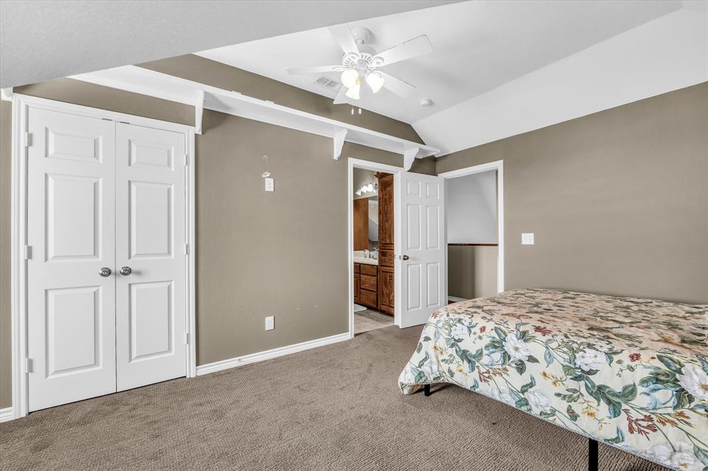 613 Bone Road Valley Mills, TX 76689 - Photo 18 of 40 a bedroom with a large bed and chandelier fan