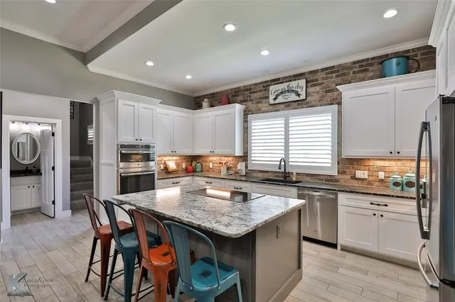 a kitchen with granite countertop a sink and appliances
