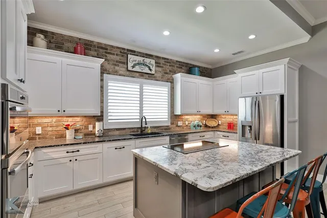 a kitchen with refrigerator and cabinets