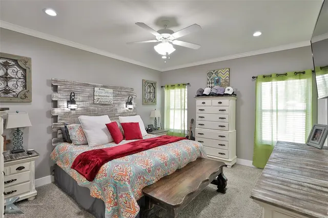 a bedroom with a large bed and a flat screen tv