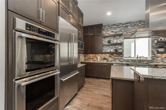 a kitchen with granite countertop a stove and steel stainless steel appliances