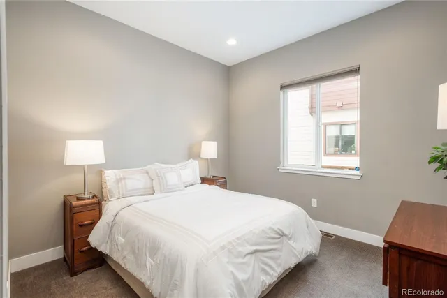 a bedroom with a bed and a lamp