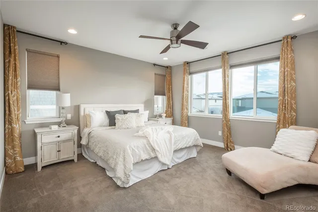 a spacious bedroom with a bed and a couch