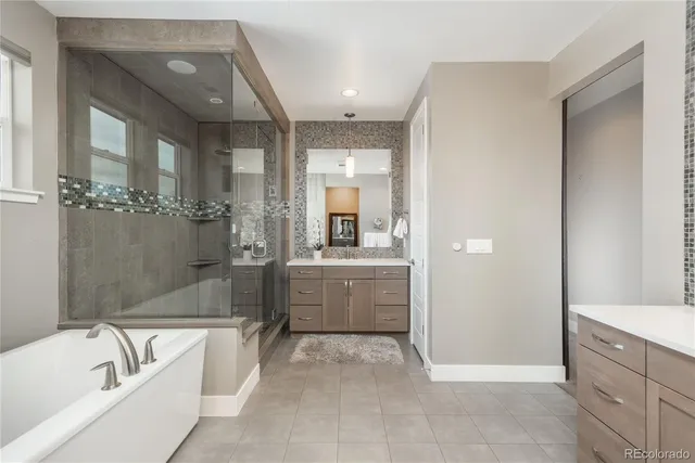 a bathroom with a tub a sink and mirrors
