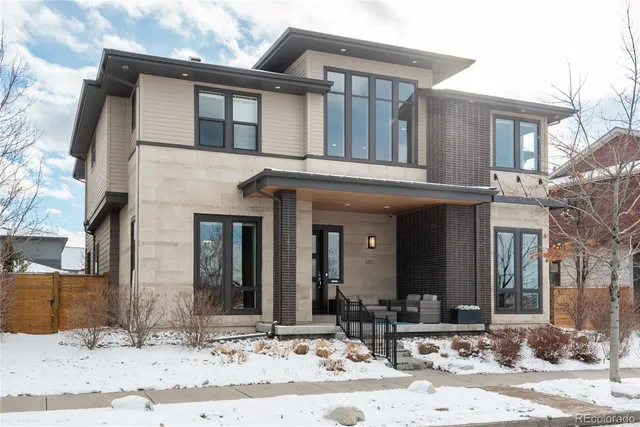 a view of a brick house with large windows