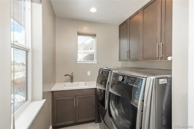 a bathroom with a sink a washer and dryer