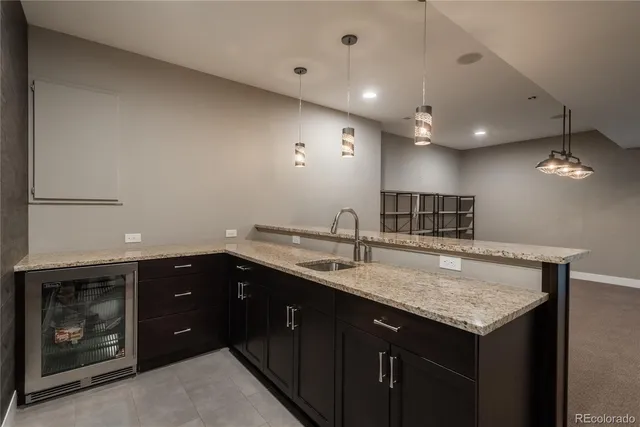 a kitchen with a sink a counter space and cabinets