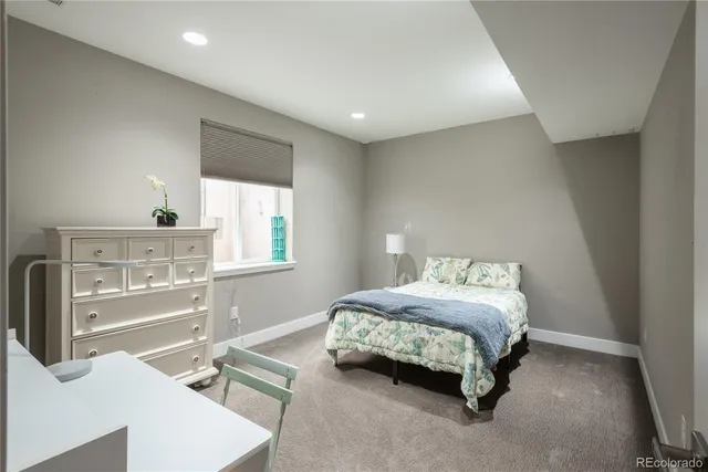 a spacious bedroom with a bed and large cabinets