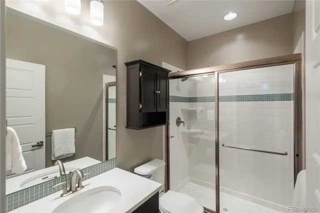 a bathroom with a sink toilet and shower