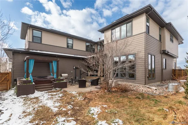 a view of a house with a yard covered in snow
