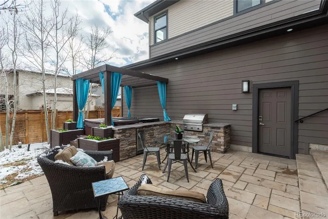 a view of a patio with table and chairs and potted plants