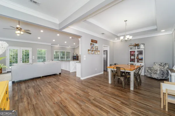 an empty room with window and wooden floor