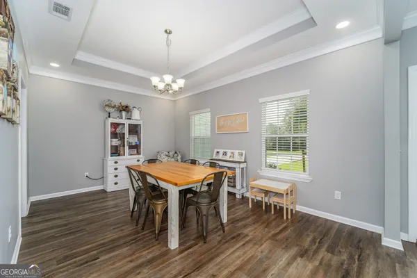 a living room with furniture and kitchen view