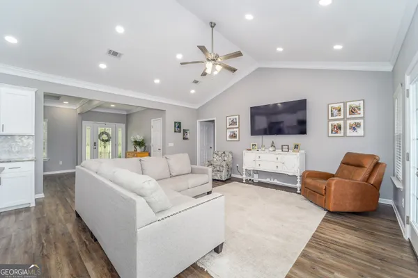 a kitchen with stainless steel appliances granite countertop a sink cabinets and wooden floor