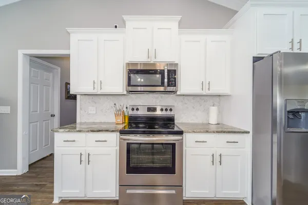 a view of a hallway with washer and dryer