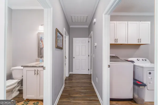 a bathroom with a granite countertop toilet a sink and a mirror
